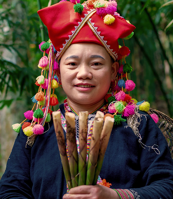 Woman in Vietnam holding bamboo shoots. Credit: GREAT program