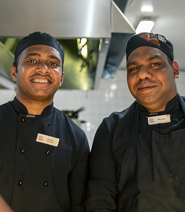 Jowave (left) and Marcellus, both commis chefs, are friends and colleagues at Ayers Rock Resort. Credit: Pacific Labour Facility