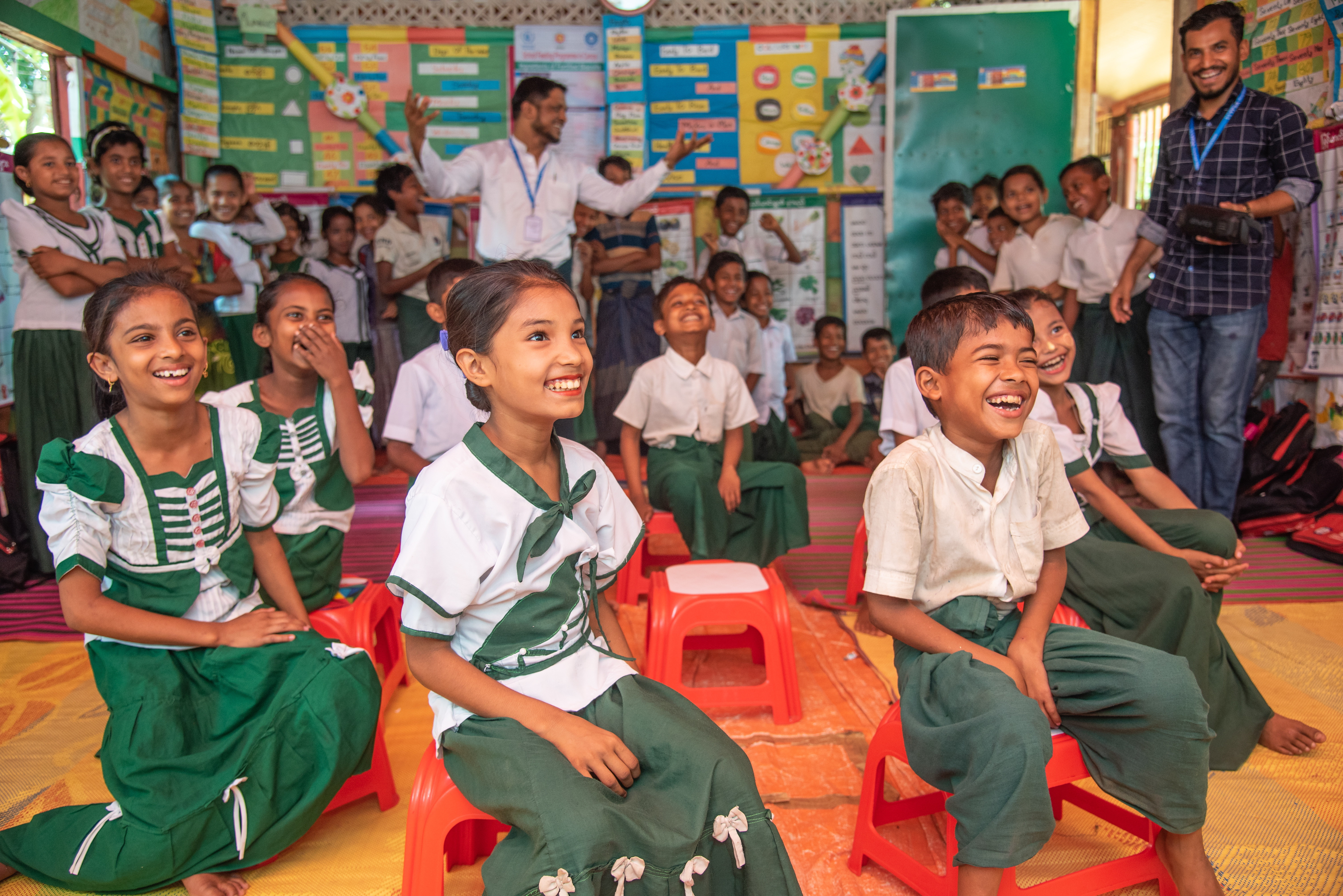 Children in classroom, teacher at back 